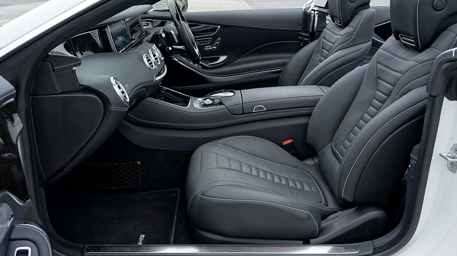 Explore the sleek and luxurious interior design of a Mercedes-Benz car with premium leather seats and modern controls.
