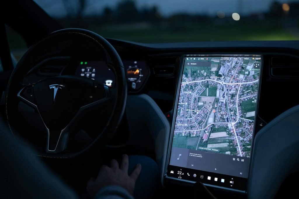 Explore the advanced touchscreen navigation in a modern electric vehicle's sleek interior at night.